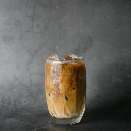 Photo for Iced of coffee cup on glass cup isolated black marble background - Royalty Free Image