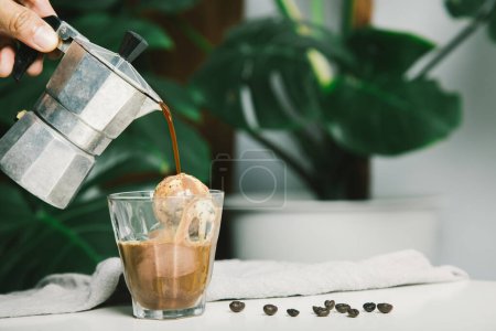 Photo for Homemade Affogato, Italian Moka coffee pot, affogato is dessert with coffee as base ingredient typically scooping a scoop of gelato or vanilla ice cream into a cup. Then pour one shot of hot espresso. - Royalty Free Image