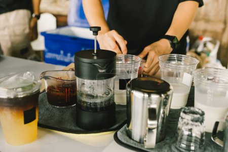 Photo for Preparing, brew or pouring  into a glass of milk to set the iced cocoa on the table with the coffee-making equipment. Selective, soft focus - Royalty Free Image