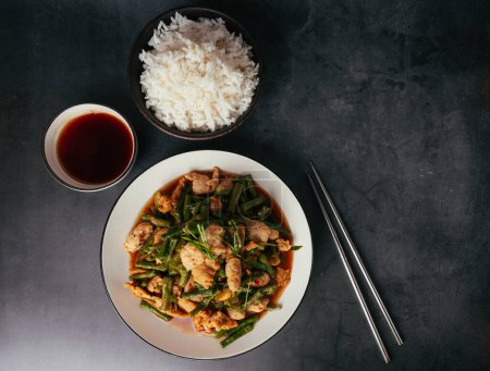 Tasty Stir-fried pork and red hot curry paste with asparagus bean or long bean and Ingredients are oyster sauce, fish sauce, sugar, kaffir lime leaves in the dish Eat with cooked rice. Thai cuisine