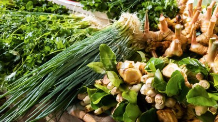 Photo for Ginger, galangal, lemongrass, coriander, kaffir lime leaves, spring onion Assorted fresh vegetables on the table for sale in the fresh vegetable market. - Royalty Free Image