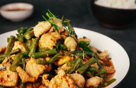 Close up, Tasty Stir-fried pork and red hot curry paste with or long bean and Ingredients are oyster sauce, fish sauce, sugar, kaffir lime leaves in the dish Eat with cooked rice. Thai food