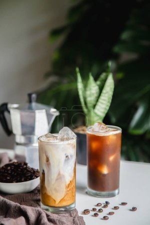Photo for Iced of latte coffee and ice blak coffee cup on glass cup on white table - Royalty Free Image