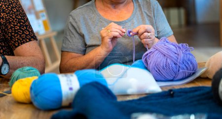 Photo for Crochet Club. Elderly women friends knitting together - Royalty Free Image