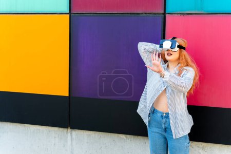 Redhead girl experiences virtual reality at university