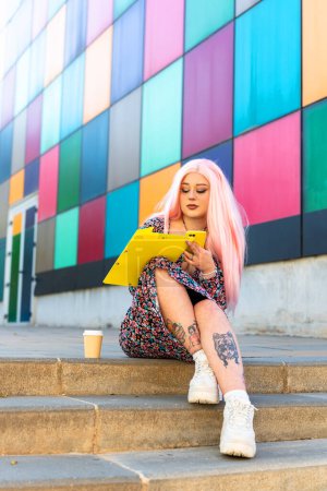 Girl with pink hair taking notes at the university
