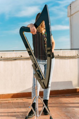 Photo for Hungarian harpist with an electronic harp making ancient music - Royalty Free Image