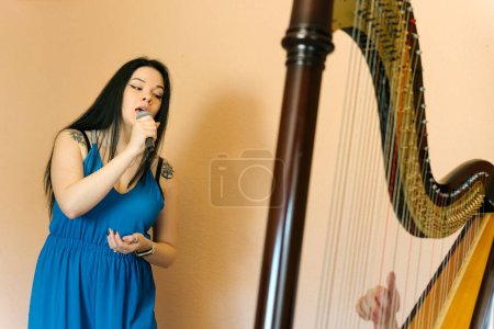 Photo for Opera singer rehearsing with a harpist - Royalty Free Image