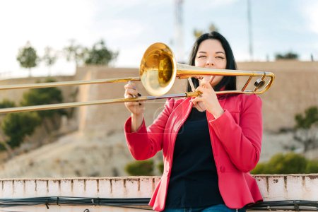 Young girl trombonist playing cheerful
