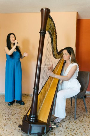 Photo for Harp and voice duo rehearsing together - Royalty Free Image