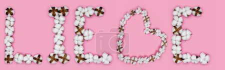 Foto de Word liebe from deutch language means love, made of cotton flowers. Concept of organic candid true love. Letter made in shape of heart of cotton bud. Pink background - Imagen libre de derechos