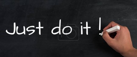 Photo for Just do it is standing on the chalkboard, coaching concept, motivation and education, time to start - Royalty Free Image