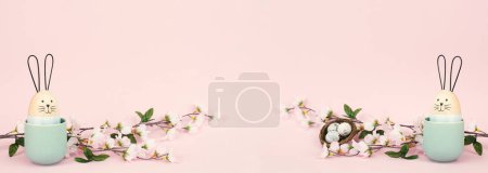 Photo for Cute bunny or rabbit with cherry blossoms and an easter egg nest, spring holiday greeting card and banner - Royalty Free Image