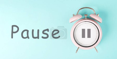 Photo for Alarm clock with pause sign, pastel color, time for a break, having lunch or a cup of coffee - Royalty Free Image