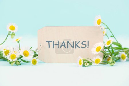 Photo for Thanks card surrounded by flowers, being thankful, support, help and charity concept, positive attitude - Royalty Free Image