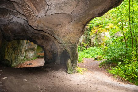 Huel Lee or Hohllay on the Mullerthal trail in Luxembourg, open cave with view to the forest, sandstone rock formation 