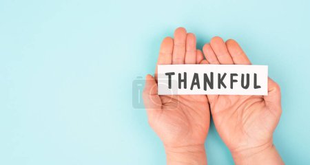 Thankful sign in hand, thank you, support, help and charity concept, positive attitude 