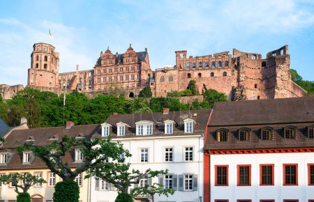 Photo for Heidelberg, mediaevial castle, red sandstone ruins tower looms majestically over the Neckar river and valley - Royalty Free Image