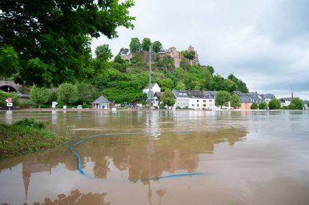 Flood of the river Saar, Saarburg in Saarland, Germany, flooded trees and paths, high water level, climate change 