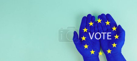EU election, hand with european union flag, blue and yellow stars, citizens of Europe voting Parliament