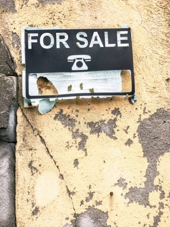 Old advertisement of a house for sale. Real estate crisis concept.