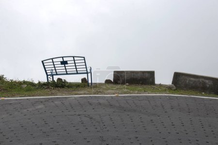 Photo for Empty bench in a lonely and quite place in Kurseong city of Darjeeling. From the bench view of a heaven can be seen. - Royalty Free Image