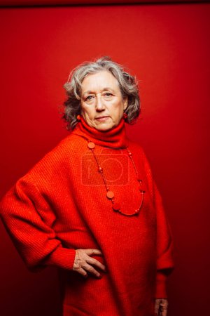 Photo for Senior woman wearing red clothes over a red background - Royalty Free Image