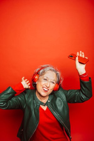 Photo for Senior woman wearing red clothes, over a red background - Royalty Free Image