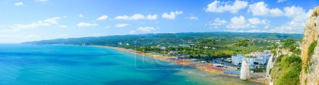 Photo for Vieste, Italy. Panoramic view from the top of the Lungomare Enrico Mattei beach with the famous Pizzomunno Monolith rising into the sea. Banner header. September 5, 2022. - Royalty Free Image