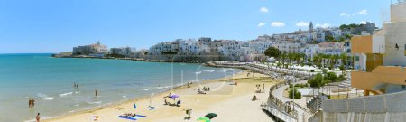 Photo for Vieste, Italy. View of the town with the beach of the Lungomare Cristoforo Colombo with some people. In the distance the Church of San Francesco. September 5, 2022. - Royalty Free Image