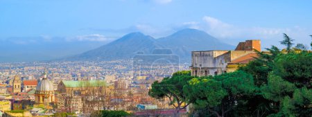 Naples, Italy. View with some pine trees in foreground, from Corso Vittorio Emanuele. In the background Mount Vesuvius. Banner Header image. January 3, 2023.