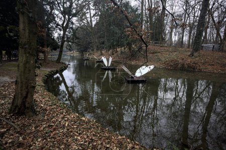 Foto de Estanque en un parque en otoño con escultura en forma de mariposa en el agua - Imagen libre de derechos