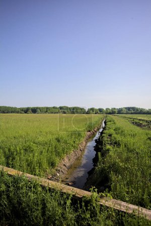 Trench with water in the middle of fields