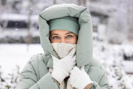 Photo for Young woman in warm clothes on a cold snowy day - Royalty Free Image