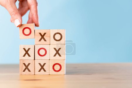 Photo for Tic tac toe concept. Business woman wins the OX game. Wooden block tic tac toe board game on wood table - Royalty Free Image