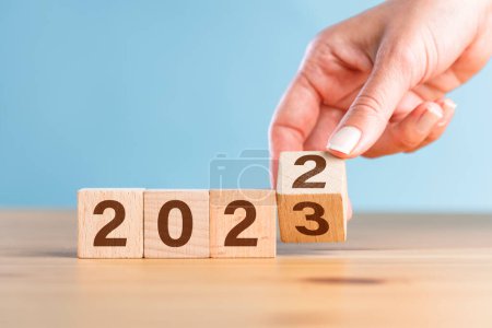 Téléchargez les photos : Cube de bloc en bois flips entre 2022 à 2023 pour le changement et la préparation de la nouvelle année - en image libre de droit