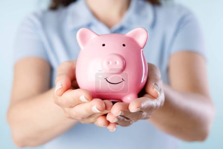 Photo for Woman holding piggy bank - Royalty Free Image