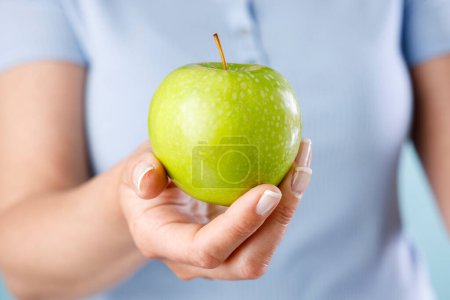 Photo for Woman holding green apple - Royalty Free Image