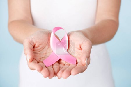 Photo for Woman hands holding pink ribbon. Breast cancer awareness concep - Royalty Free Image