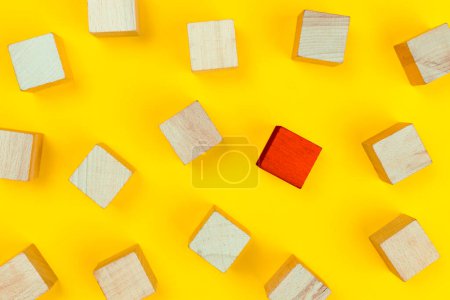 Photo for Red wooden block standing out from the group wooden blocks on yellow background. Leadership and divergent views concept - Royalty Free Image