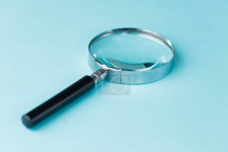 Photo for Magnifying glass on blue backgroun - Royalty Free Image