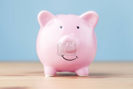 Photo for Piggy bank on wooden table - Royalty Free Image