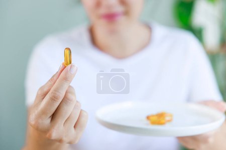 Photo for Woman holding and showing soft gel capsule - Royalty Free Image