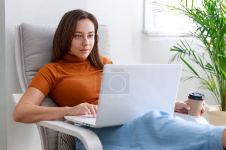 Photo for Young woman using laptop computer at home. Home work or online shopping, distance learning, education online, e-commerce, freelance concep - Royalty Free Image