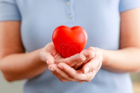 Woman holding red heart. Health insurance, donation charity concept 