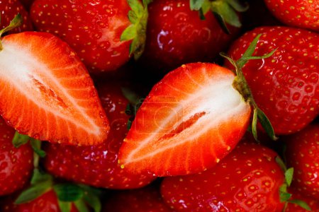 Photo for Fresh strawberries as background. Close-up shot of sliced fresh strawberry background - Royalty Free Image