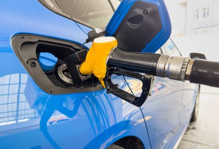 Photo for Petrol pump filling fuel nozzle in fuel tank of car at gas station. Refuel fill up with petrol gasoline. Petrol industry and service - Royalty Free Image