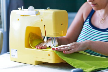 Photo for Cropped shot of an unrecognizable woman making a garment at hom - Royalty Free Image