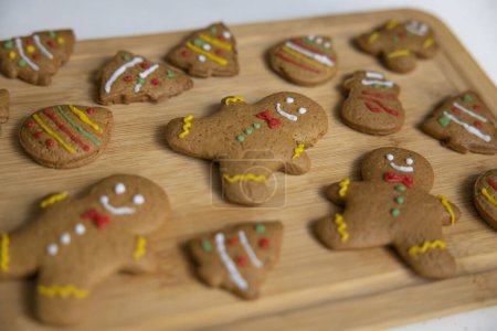 Photo for Decorated gingerbread cookies on wooden tray. Homemade Christmas cookies on wooden background - Royalty Free Image