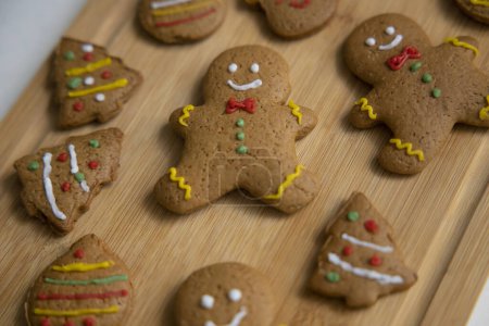 Photo for Decorated gingerbread cookies on wooden tray. Homemade Christmas cookies on wooden background - Royalty Free Image